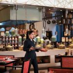Food Exchange team member serving dishes in the restaurant at Novotel New Delhi Aerocity