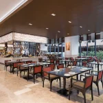 Spacious Food Exchange restaurant dining area at Novotel New Delhi Aerocity