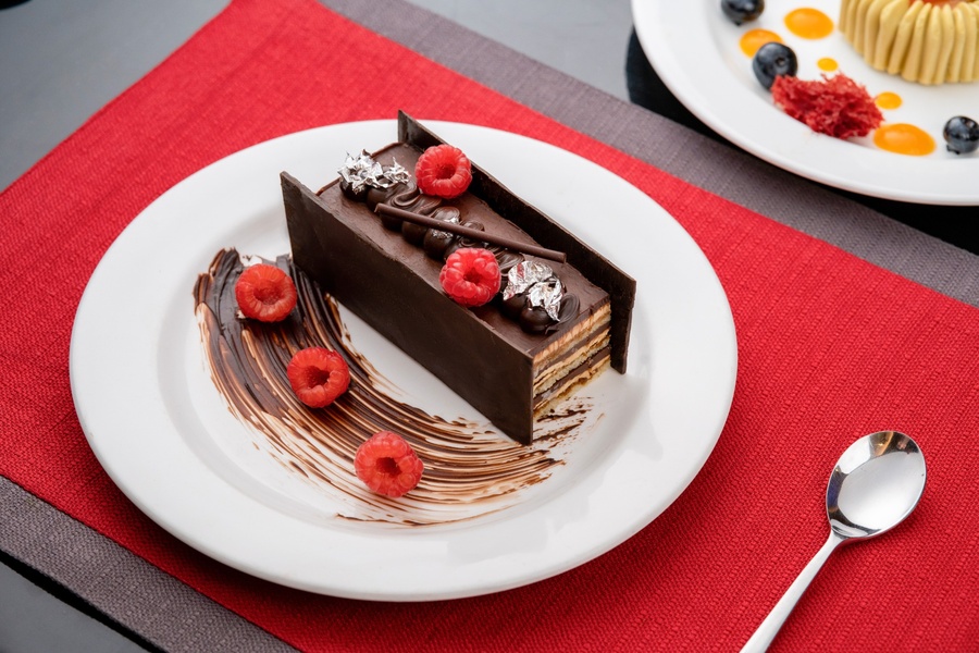 Chocolate layered dessert with fresh raspberries at Food Exchange Aerocity Delhi