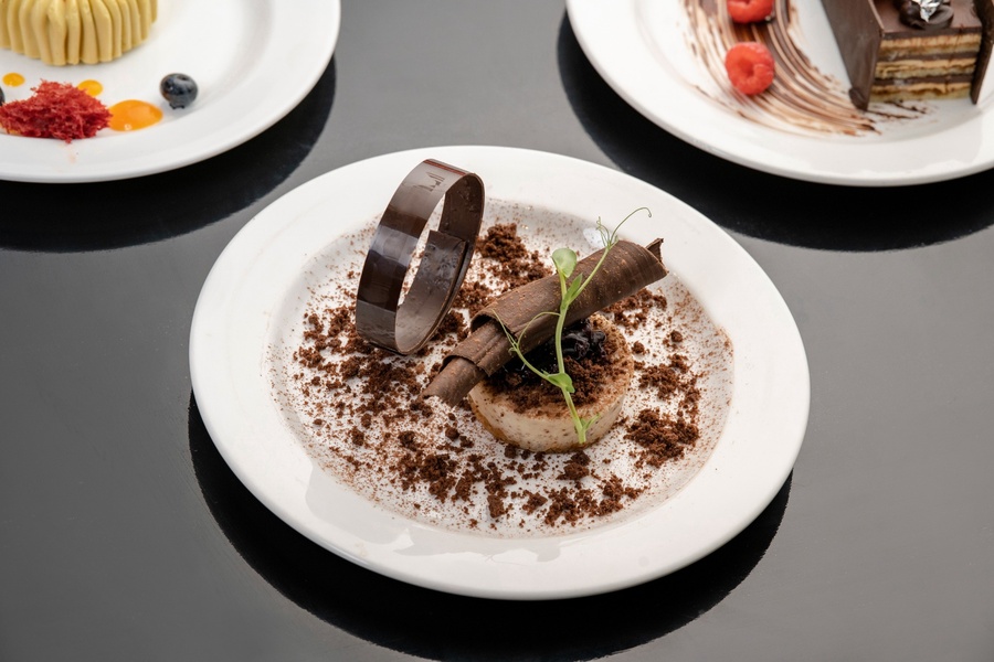 Chocolate dessert with decorative chocolate curls at Food Exchange Aerocity Delhi