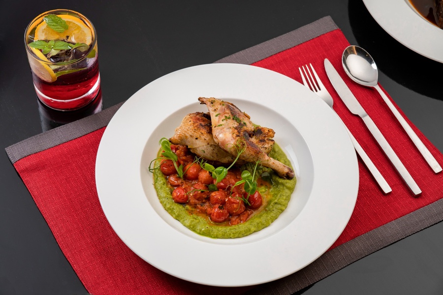 Roasted chicken with cherry tomatoes and green purée at Food Exchange Aerocity Delhi